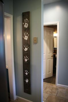 a handprinted sign on the wall in a hallway next to an open door