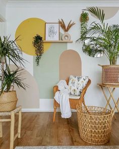 a living room filled with lots of plants and wicker baskets on top of wooden floors