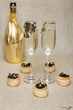 champagne being poured into wine glasses next to cookies