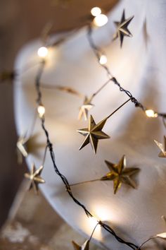 a white plate topped with gold stars and lights