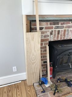 a fire place with some tools on the floor