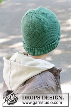 a young boy wearing a green knitted hat on top of his head with the words drops design above it