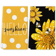 two yellow and black towels with white polka dots, one has sunflowers on it