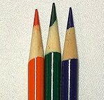 four colored pencils lined up in a row