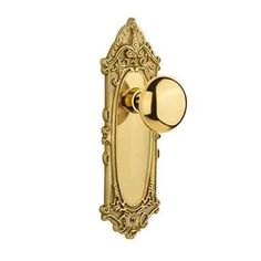 an ornate brass door handle on a white background