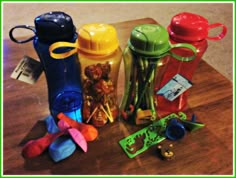 several different types of plastic items on a wooden table with a green border around them