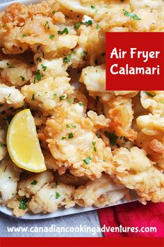 an air fryer calamari with lemon wedges and parsley