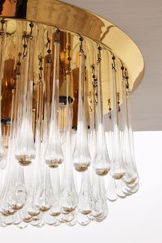 a chandelier with many wine glasses hanging from it