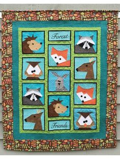 a quilted wall hanging with animals on it