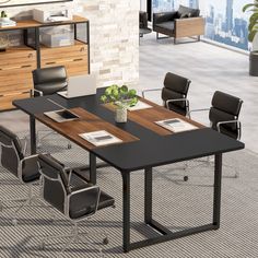 an office table with chairs and a laptop on it