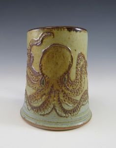 a ceramic cup with an octopus design on it