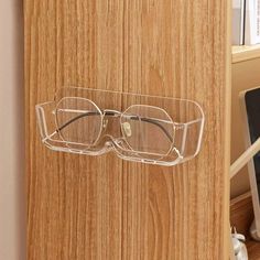 a pair of glasses hanging on the side of a wooden door