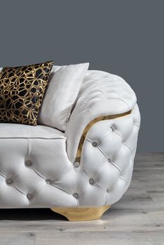 a white couch sitting on top of a hard wood floor