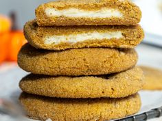 a stack of cookies sitting on top of a glass plate next to an orange slice