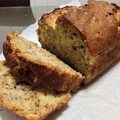 a loaf of banana bread sitting on top of a piece of paper