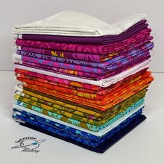 a stack of multicolored cloths sitting on top of each other