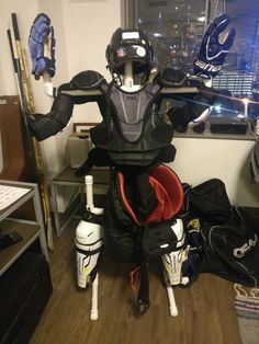 a hockey goalie's gear sits in front of a window