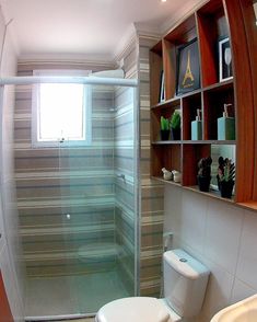 a bathroom with a toilet, shower and shelves