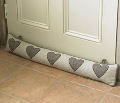 a pillow with hearts on it sitting in front of a door