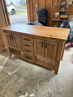 a large wooden cabinet sitting inside of a garage