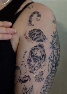 a woman's arm with tattoos on it