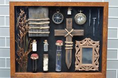 a shadow box filled with different items like a cross, clock and other things in it