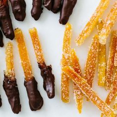 chocolate covered candies and orange peels on a white plate