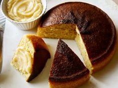 a bundt cake with two slices cut out next to a cup of whipped cream