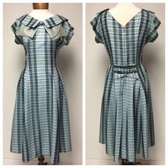 A 1950's pale teal plaid dress, drop sleeve, V neck front and back with front collar and grey organdy bow. Probably a rayon. Black, grey stripes create the design with horizontal silver threads. Princess seams in the front and 2 darts at the back give the bodice it's shape, falling into 7 gores creating a full skirt. The back center skirt panels start at a dropped V waist with 4 pleats and a belt design with 2 covered buttons. A back metal closing zipper. The true color is represented in the dou Fitted Plaid Dress For Garden Party, Fitted Vintage Plaid Dress For Spring, Vintage Plaid Dress For Garden Party, Fitted Plaid Vintage Dress, Fitted Vintage Plaid Dress, Vintage Knee-length Plaid Dress For Spring, Vintage Lined Plaid Dress, 1952 Wrap Dress, 1950s A-line Dress With Buttons