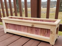 a wooden planter sitting on top of a wooden deck