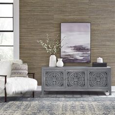 a living room scene with focus on the sideboard and rug in the foreground