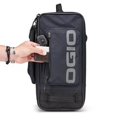 a person is holding a cell phone in a case that has the word oggo written on it