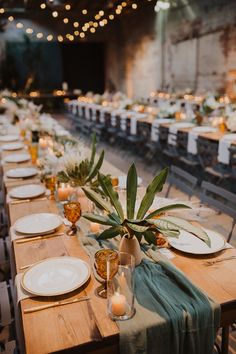 the tables are set with candles and place settings