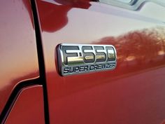 an emblem on the side of a red car that says f250 super crazes