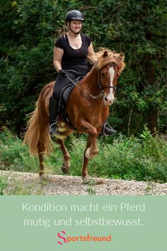 a woman riding on the back of a brown horse in front of green bushes and trees