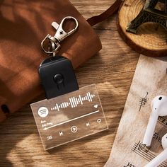 an earbud is sitting on top of a piece of paper next to a pair of headphones