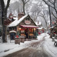 a small christmas shop in the middle of a snow covered park with benches and tables