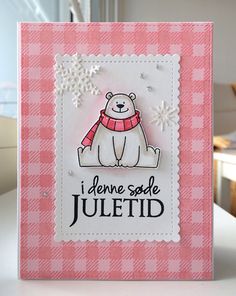 a pink and white card with a bear on it