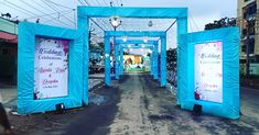 the entrance to an event is decorated with blue tarp and white columns, which are lined