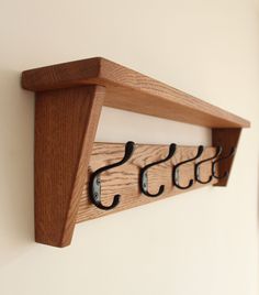 a wooden coat rack with hooks on it