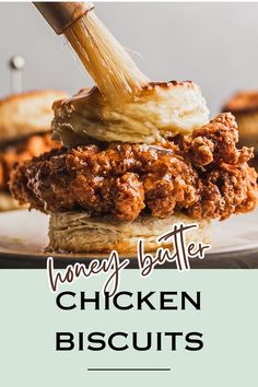 a close up of a chicken biscuit on a plate with the words honey butter chicken biscuits