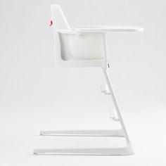 a white desk chair with a red button on the back and arm rests against a white background