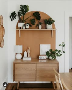 an image of a room with plants on the shelf and other things on the table