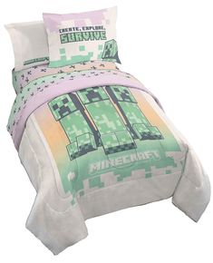 a bed in a room with a minecraft comforter and pillow cases on it