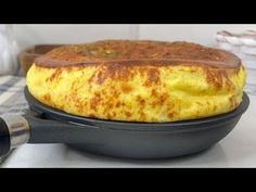 an omelet sitting on top of a black pan