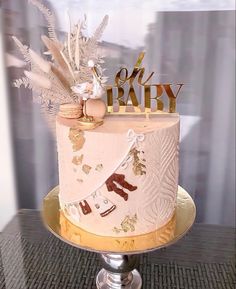 there is a cake that has been decorated with gold and white decorations