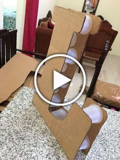 an open cardboard box sitting on top of a counter next to a chair and table