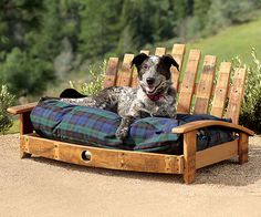 a dog laying on top of a bed made out of wooden pallets and blankets