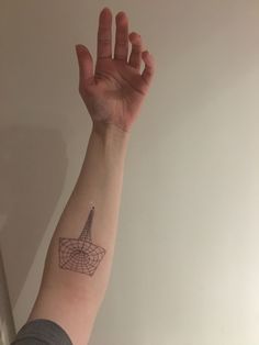 a person's arm with a small tattoo on it