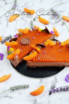 there is a piece of pie with orange slices on the plate and purple flowers around it